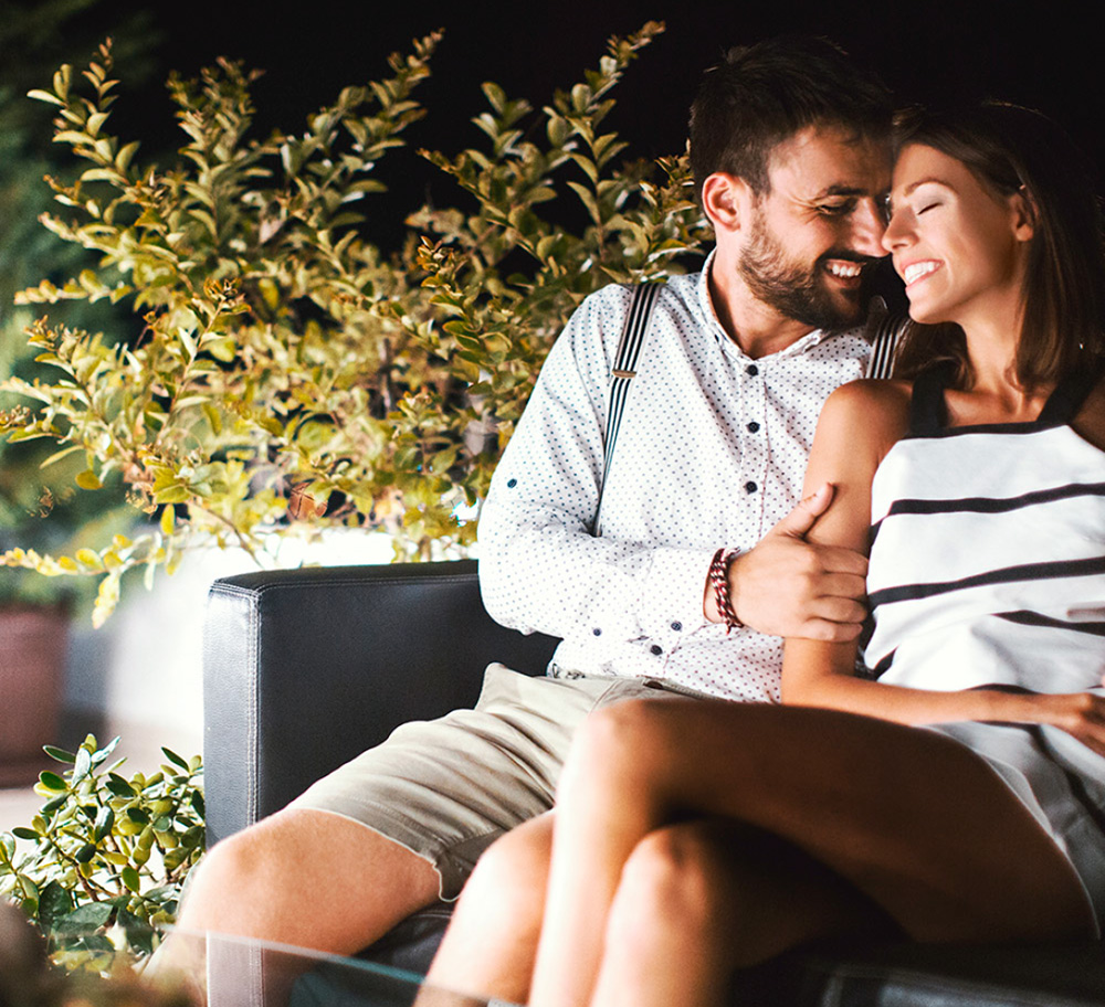 Couple sitting together outside at night