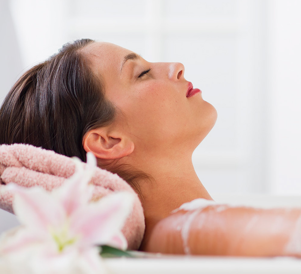 Woman relaxing taking a bath at a spa